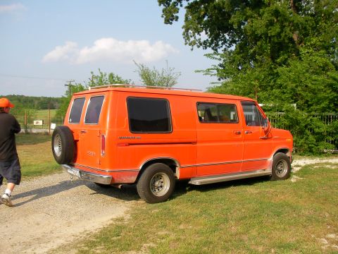 1978 Ford E150 - This van has a spare tire mounted on the rear door and a roof rack.