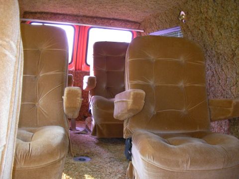 1978 Ford E150 - Plush tan captain's chairs and shag carpet visible inside the van's interior.