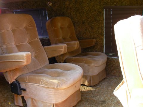 1978 Ford E150 - The interior of a van shows plush velour seating and shag carpeting.