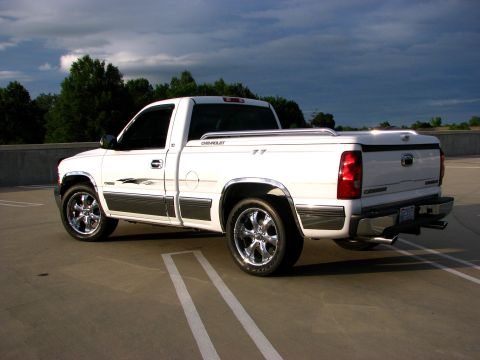 2002 Chevrolet Silverado 1500 - White 2002 Chevrolet Silverado 1500 pickup truck parked in a lot under a cloudy sky.