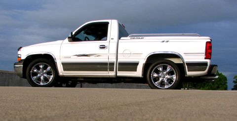 2002 Chevrolet Silverado 1500 - A white 2002 Chevrolet Silverado 1500 pickup truck is shown from the side against a cloudy sky.