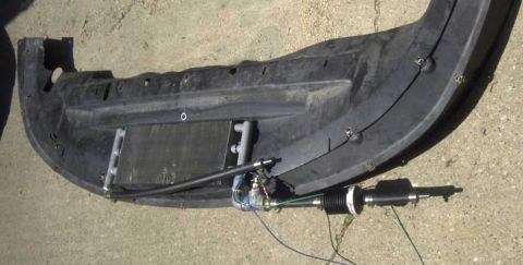 1997 Ford Taurus - Car bumper with transmission cooler and steering component, likely for aftermarket modification.