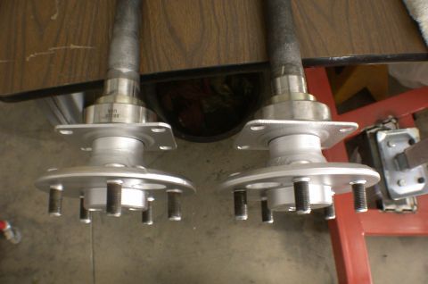 1967 Ford Galaxie - Close-up view of two disc brake conversion axle shafts, likely for a vehicle's rear end.