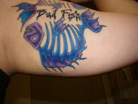 1989 Ford Bronco - A tattoo depicts a fish skeleton with the words "Bad Fish" written above it.