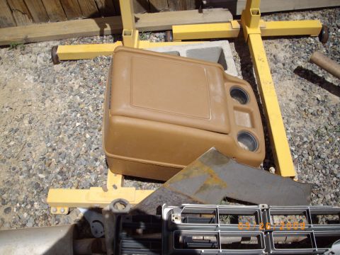 1982 Toyota 4Runner - A tan center console and a chrome grille are shown outdoors, supported by yellow equipment.