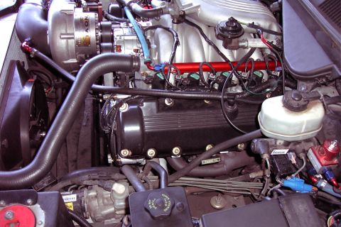 1992 Ford Crown Victoria - Close-up view of a modified engine bay, a prominent supercharger and custom fuel system components.