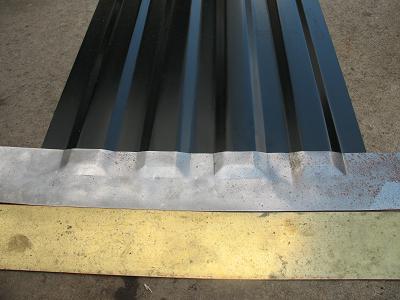 1978 Ford Bronco - Corrugated black metal sheeting is shown with a silver trim piece and a yellow surface below.