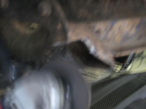 1978 Ford Bronco - A close-up, blurry shot shows the undercarriage of a vehicle, with focus on mechanical components.