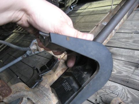 1978 Ford Bronco - A black part with "2 DEGREE OFFSET" text is held by a hand over a rusty metal component.