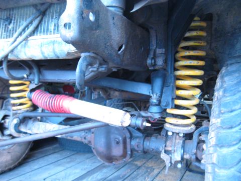 1978 Ford Bronco - Undercarriage view of a vehicle's suspension system, showing springs and shocks.