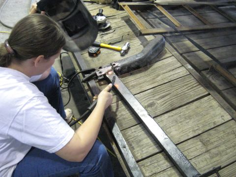 1978 Ford Bronco - Metal fabrication in progress with a person welding components together.