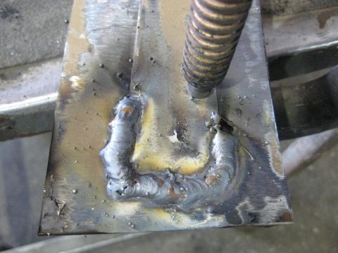 1978 Ford Bronco - Close-up of a metal part with visible welding and a threaded rod, indicating mechanical work.