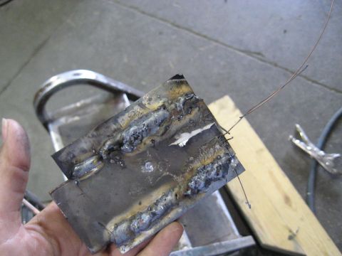 1978 Ford Bronco - Metal plate with visible welds and attached wires, held in a hand.
