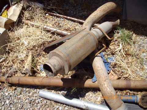 1982 Toyota 4Runner - Discarded exhaust system components lie on the ground amidst debris.