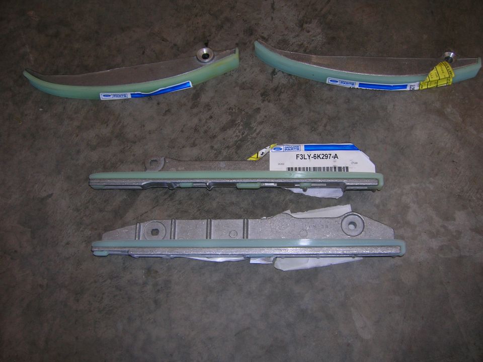 Set of timing chain guides with Ford parts labels on the floor