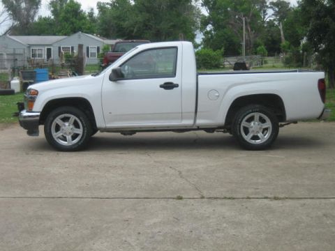 1996 Ford Thunderbird - White Chevrolet Colorado pickup truck parked on a concrete driveway with houses in the background.
