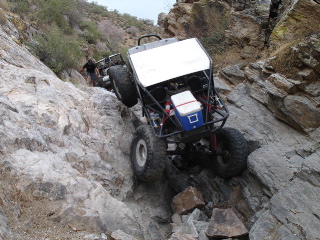 1966 Ford Bronco - This custom buggy navigates a steep, rocky incline, its off-road capabilities.