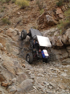 1966 Ford Bronco - This custom-built off-road buggy navigates a challenging rocky incline, demonstrating its extreme articulation and off-road capability.