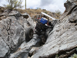1966 Ford Bronco - This custom buggy is tackling a challenging rocky terrain, demonstrating its off-road capabilities.