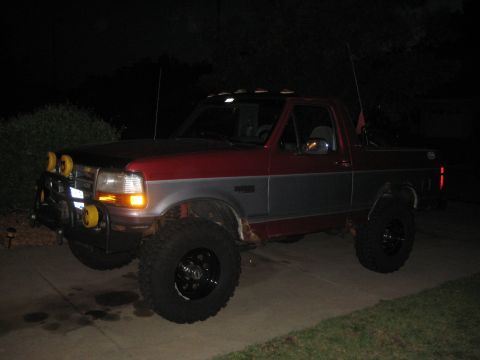 1995 Ford Bronco - This lifted 1995 Ford Bronco features a two-tone red and silver paint scheme and auxiliary off-road lighting.