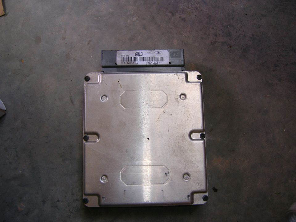 Ford engine control module PCM lying on a shop floor