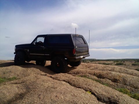 1995 Ford Bronco - This 1995 Ford Bronco is shown off-roading on a rocky landscape.