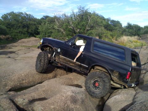 1995 Ford Bronco - This 1995 Ford Bronco is navigating a challenging rocky terrain during an off-road excursion.