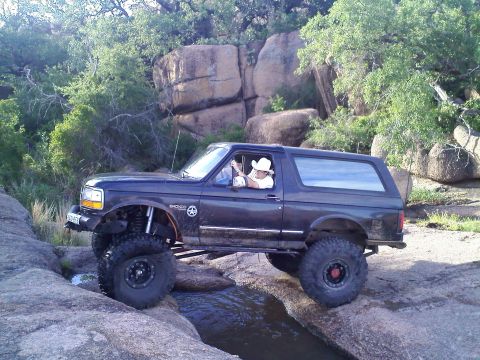 1995 Ford Bronco - This 1995 Ford Bronco is shown off-roading through a rocky stream bed.