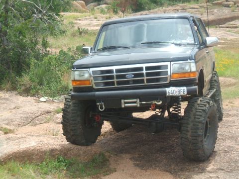 1995 Ford Bronco - This modified Ford Bronco features an aggressive lift kit and oversized tires, altering its original appearance.