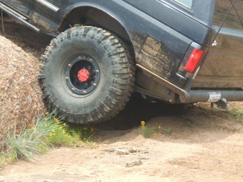 1995 Ford Bronco - This 1995 Ford Bronco is navigating a rocky trail, showing its off-road capabilities.