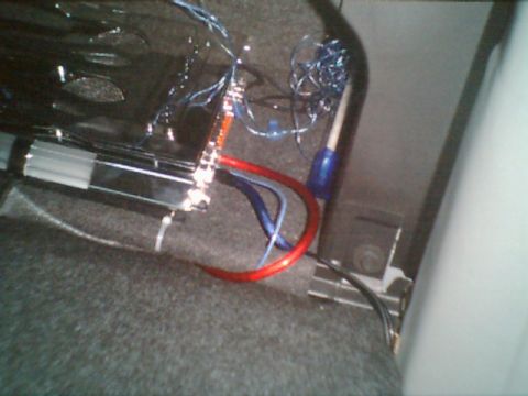 1998 Ford Taurus - Wiring for a car amplifier is visible, with red and blue power cables.