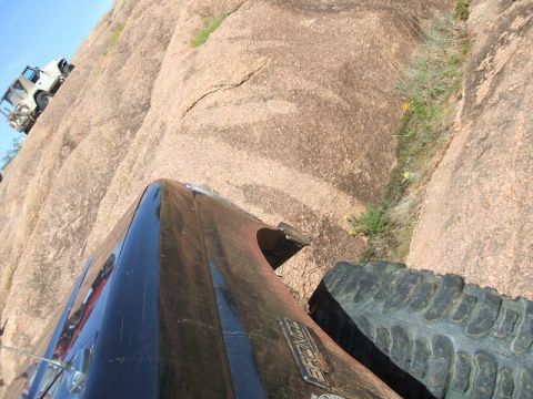 1995 Ford Bronco - Two off-road vehicles navigate a challenging rocky terrain, with the 1995 Ford Bronco in the foreground.