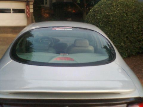 1998 Ford Taurus - Rear view of a silver 1998 Ford Taurus sedan with tinted windows and a spoiler.