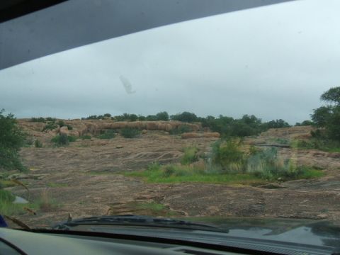 1995 Ford Bronco - Driving through a , rocky landscape with sparse vegetation and an overcast sky.