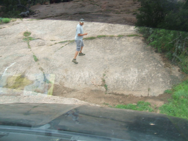 Man on rocky terrain with Supermotors watermark