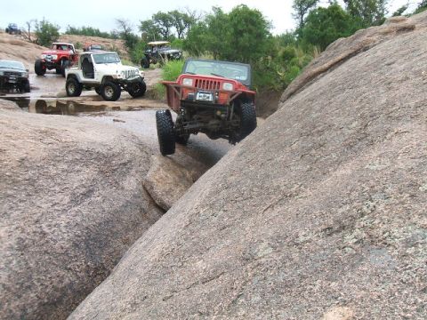 1995 Ford Bronco - Off-road vehicles tackle a challenging rocky terrain, with multiple Jeeps visible.