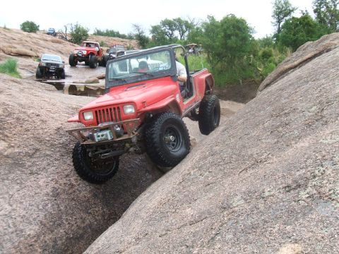 1995 Ford Bronco - Off-road vehicles navigate a challenging rocky terrain.
