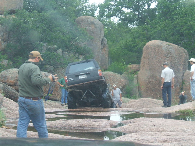 Black Toyota SUV navigating rocky terrain
