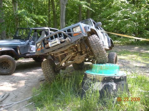 1998 Chevrolet Blazer - Modified Jeeps tackle an off-road obstacle course on a sunny day.