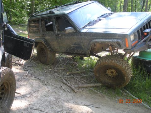 1998 Chevrolet Blazer - This modified Jeep Cherokee XJ is shown off-road with its front tire elevated.