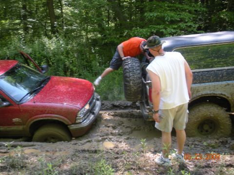 1998 Chevrolet Blazer - Two vehicles are stuck in the mud while off-roading in a wooded area.