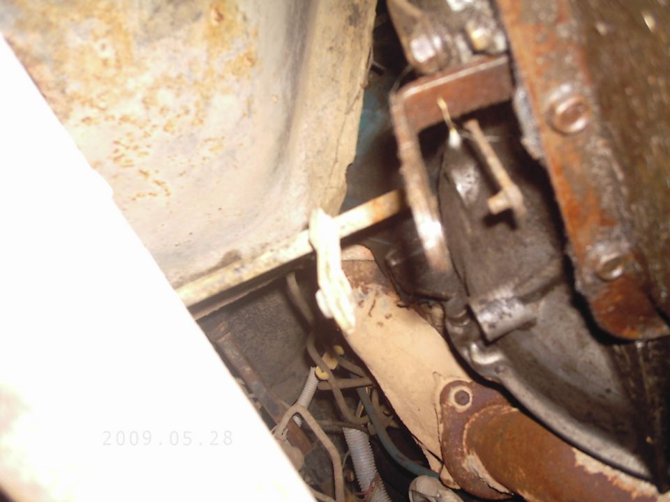 Underside view of vehicle exhaust pipe and transmission components