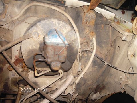 1986 Ford Bronco - Close-up view of the brake booster and master cylinder assembly in an engine bay.