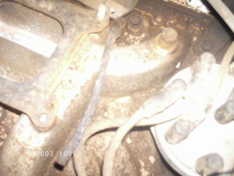 1986 Ford Bronco - This image shows a close-up view of engine components, including spark plug wires and a distributor cap.