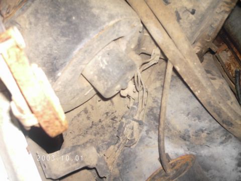 1986 Ford Bronco - Close-up view of the underside of a vehicle, showing various mechanical components and wiring.