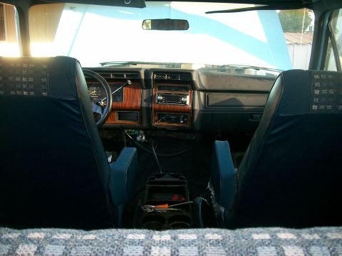 1982 Ford Bronco - The interior of a 1982 Ford Bronco shows wood grain accents on the dashboard and center console, along with bucket seats.