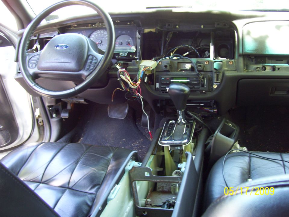 2003 Ford Crown Victoria interior with dashboard removed, showing wiring and center console