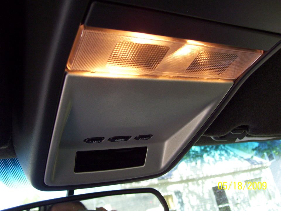 Overhead console with illuminated lights, buttons labeled LAMP, MODE, and a dark display screen