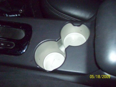 2003 Ford Crown Victoria - Close-up of car interior cup holders and center console details.