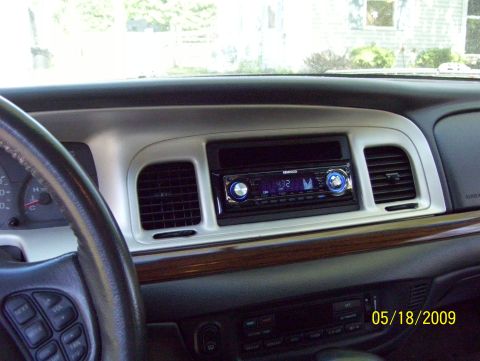 2003 Ford Crown Victoria - The interior of a car shows a dashboard with a Kenwood stereo and wood trim, dated May 18, 2009.